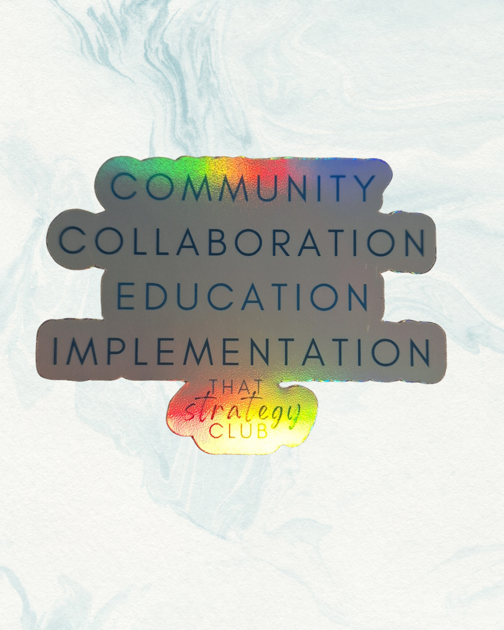 Holographic sticker with 'Community Collaboration Education Implementation' and 'That Strategy Club'.