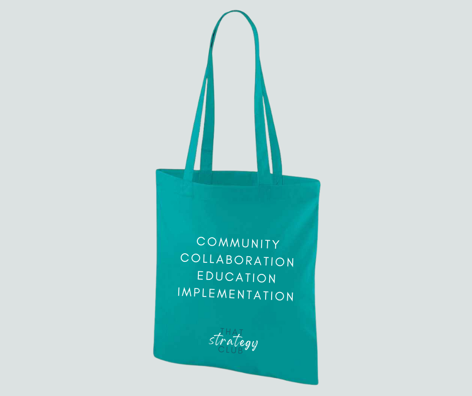 Teal tote bag with white text on a light gray background