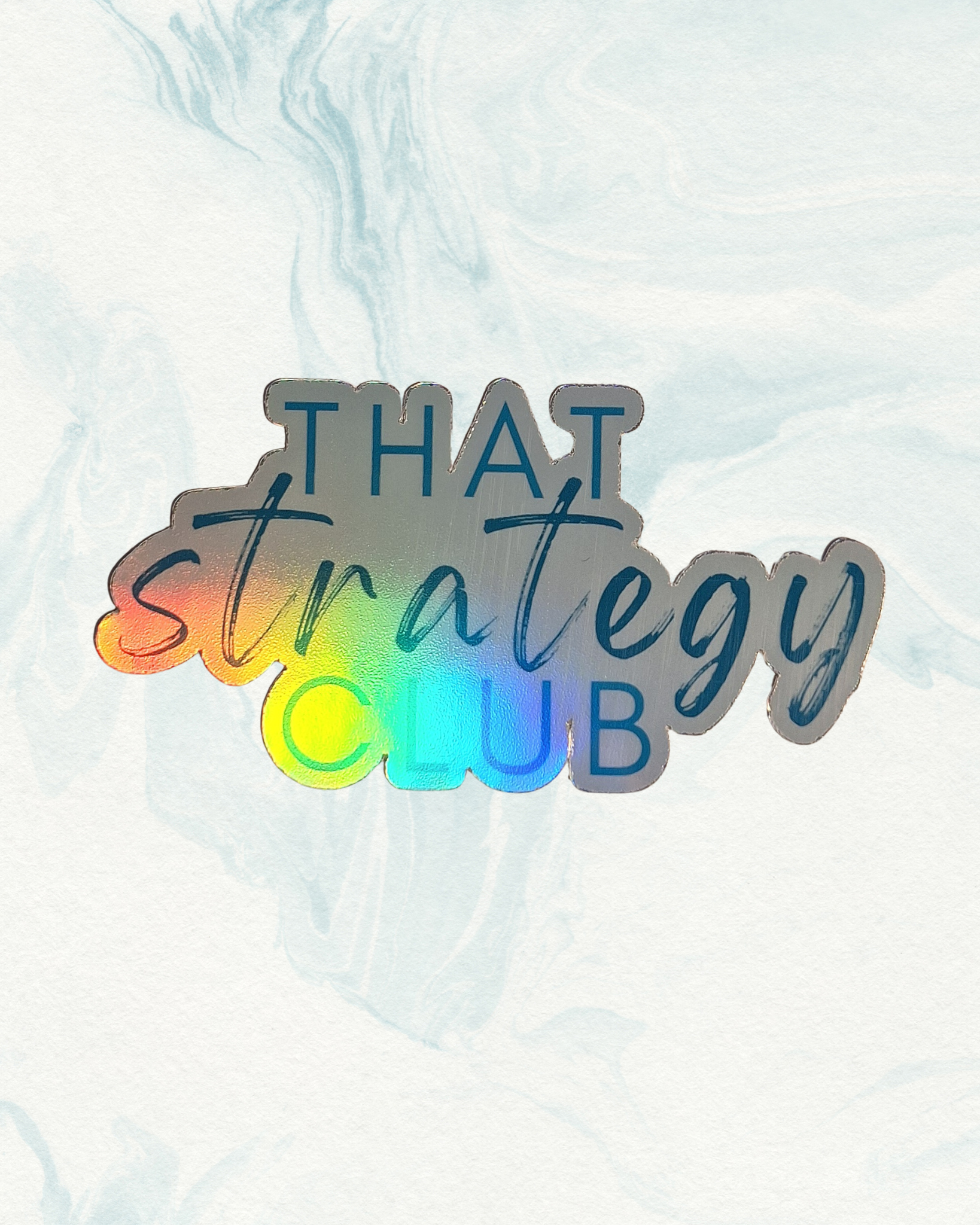 Holographic sticker with text 'THAT strategy CLUB' on a light background
