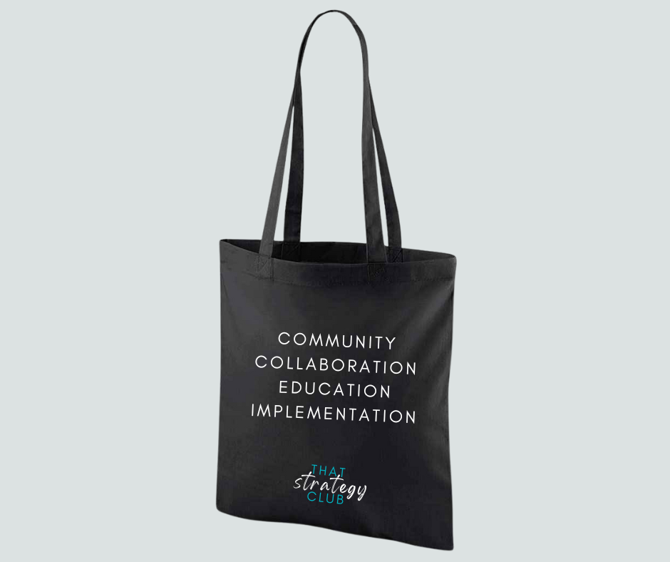 Black tote bag with text on a light gray background