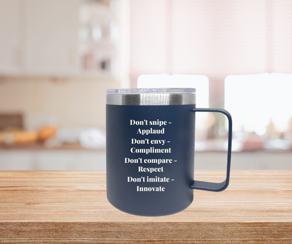 A blue cup with a silver rim and clear lid with the text Don't snipe - applaud Don't envy - compliment Don't compare - respect Don't imitate - innovate on a kitchen counter top